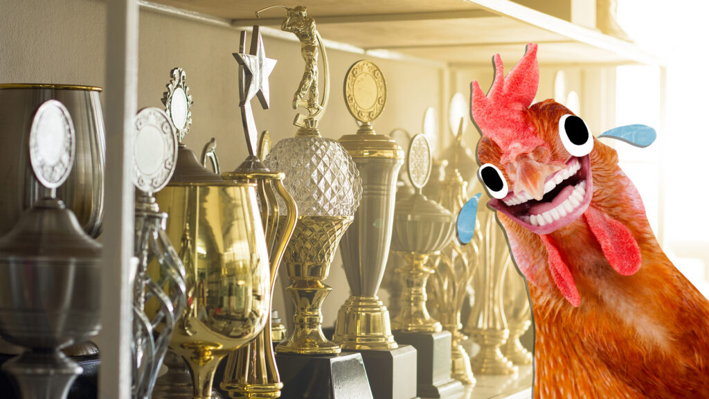 A cupboard displaying lots of sports trophies - and a chicken