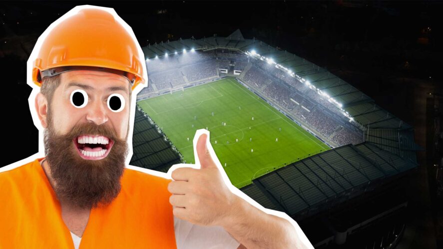 A builder giving the thumbs up outside a big football stadium