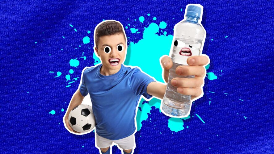 A footballer holding a refreshing bottle of water