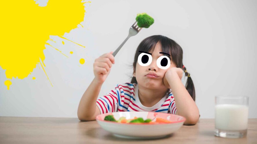 A child looking at broccoli on a fork