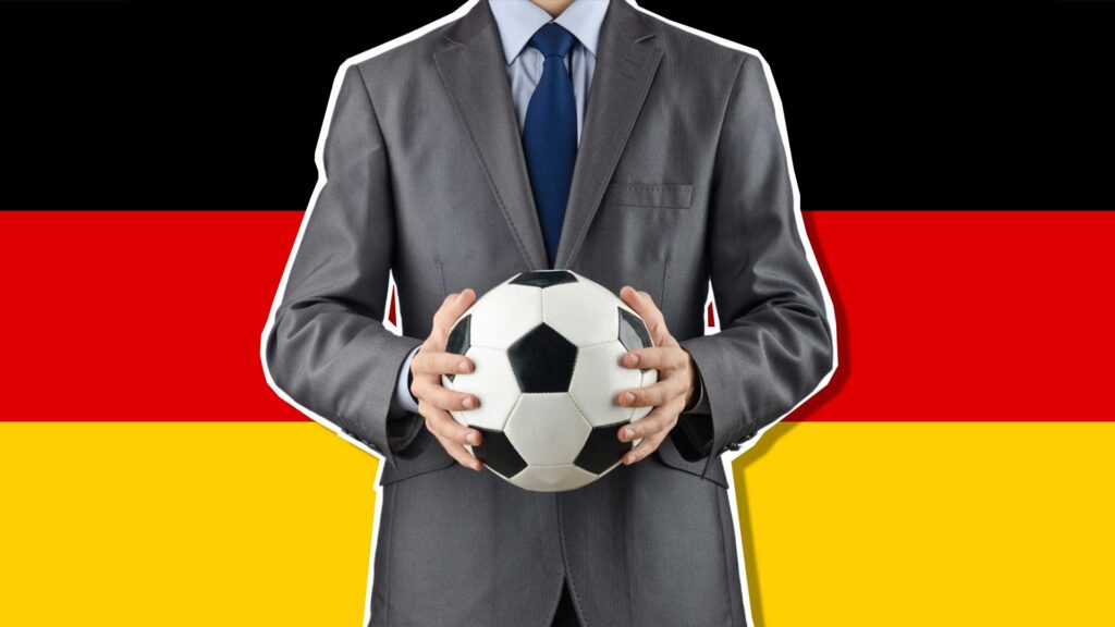 A football manager in front of a German flag