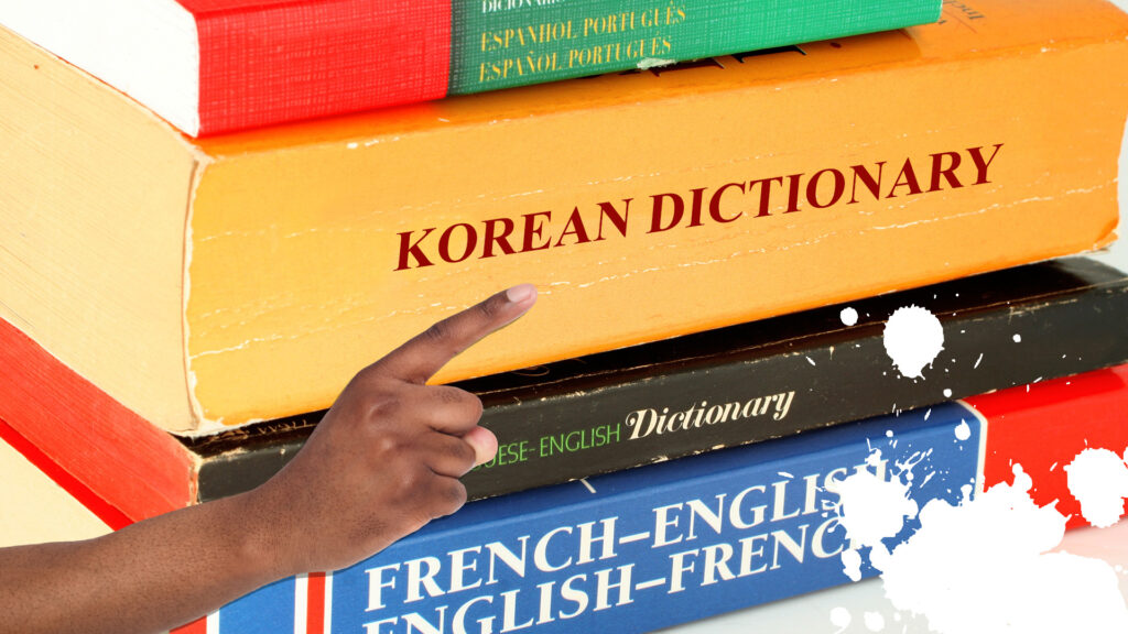 A person pointing to a Korean dictionary