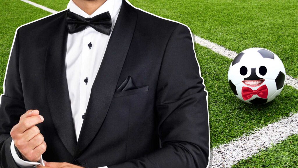 A person in a tuxedo at a football match with a ball behind them – the ball is also wearing a bowtie 