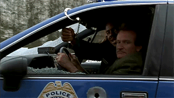 Robin Williams drives a police car in Jumanji