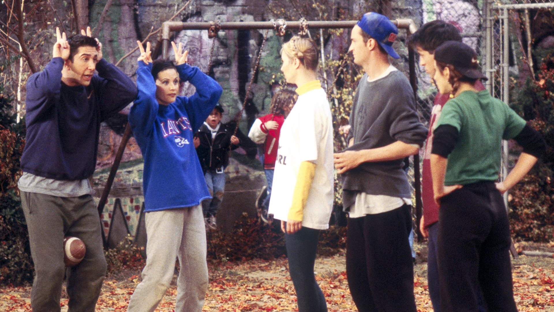 The cast play a game in the park