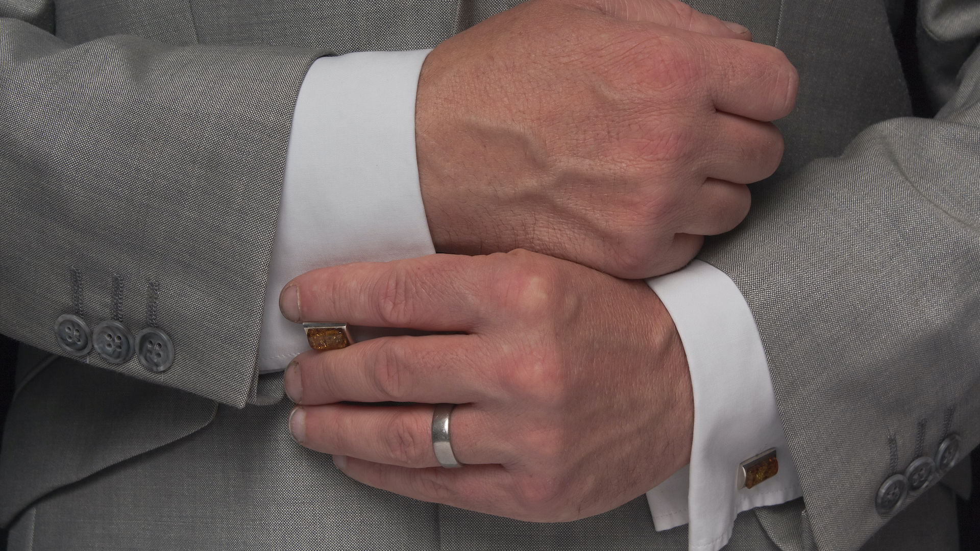 A man adjusting his cufflinks