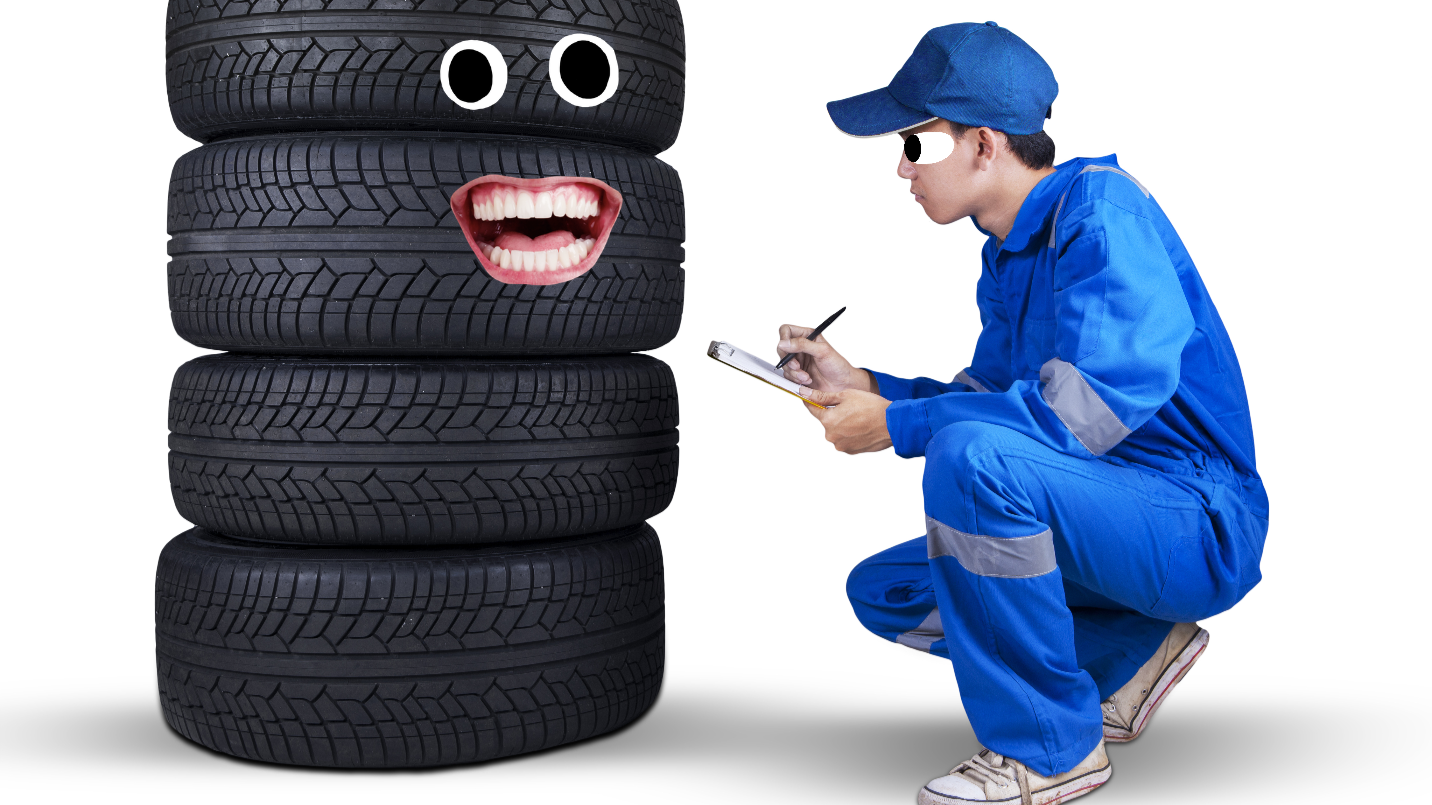 A mechanic examining tyres